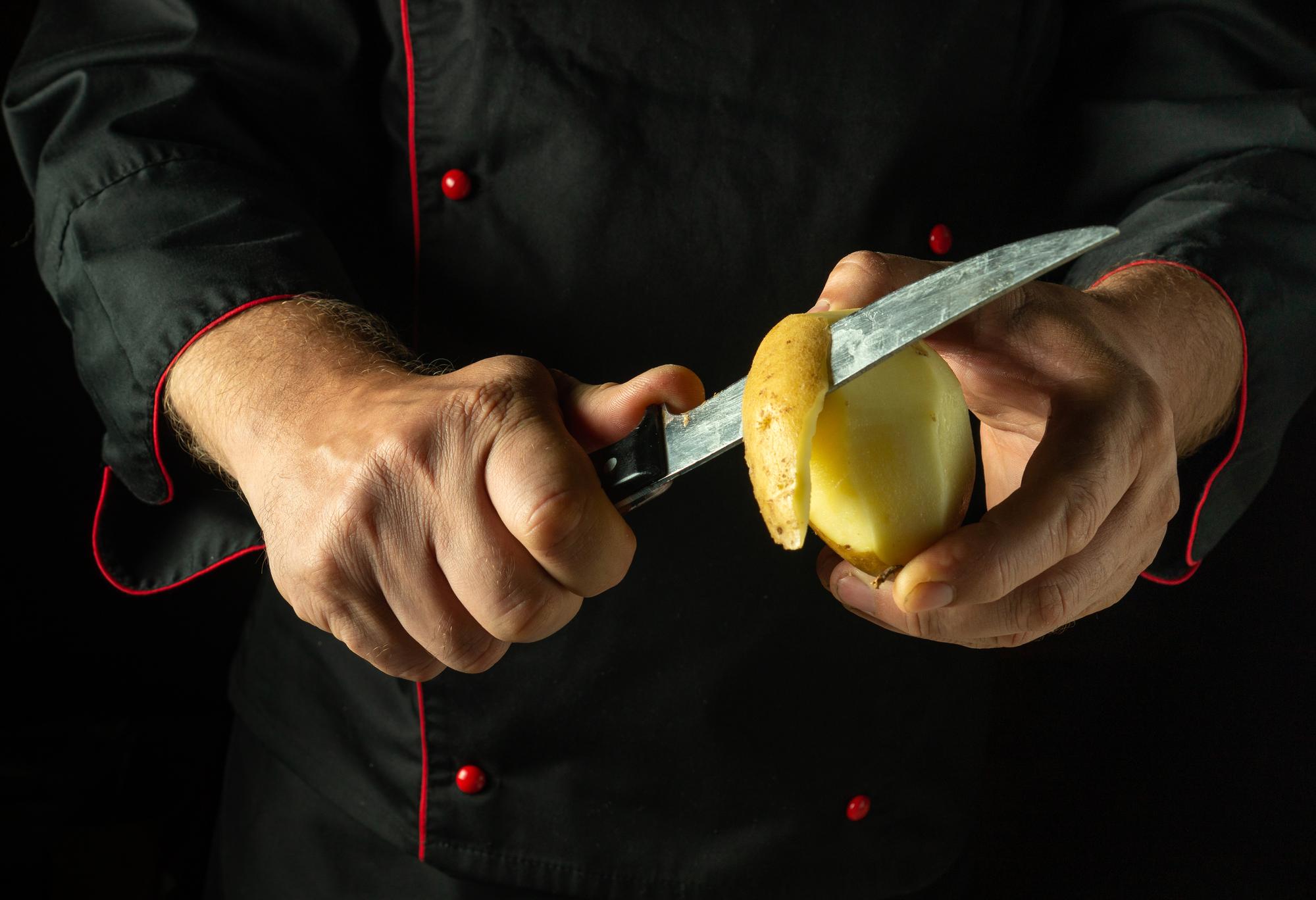 Chef demonstrating slicing technique